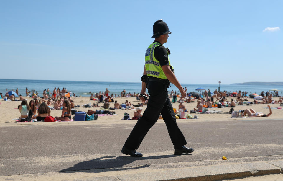 A police officer patrols along the beach in Bournemouth, Dorset, as the public are being reminded to practice social distancing following the relaxation of the coronavirus lockdown restrictions in England. (Photo by Andrew Matthews/PA Images via Getty Images)