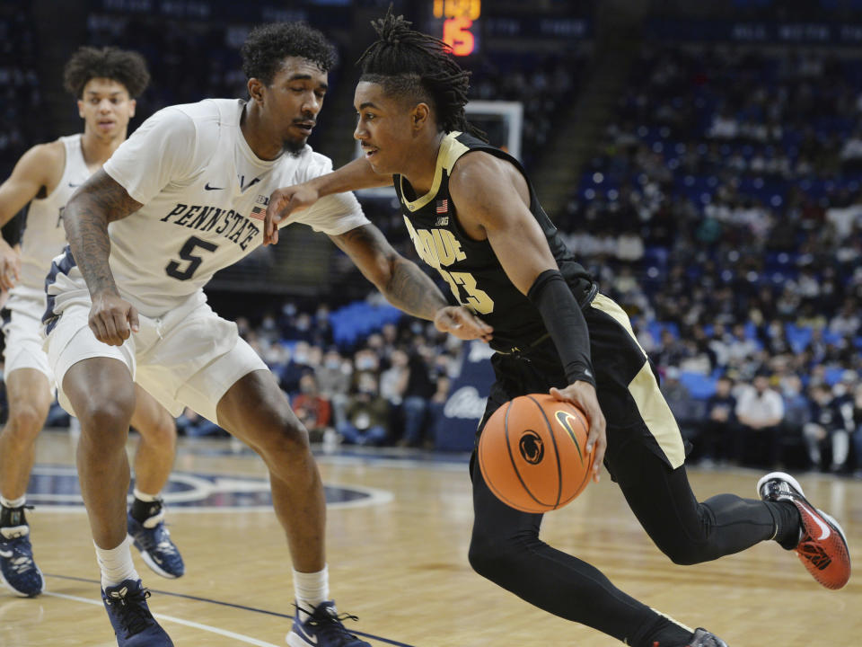 Purdue's Jaden Ivey (23) drives the baseline as Penn State's Greg Lee (5) defends during an NCAA college basketball game Saturday, Jan. 8, 2022, in State College, Pa. (AP Photo/Gary M. Baranec)