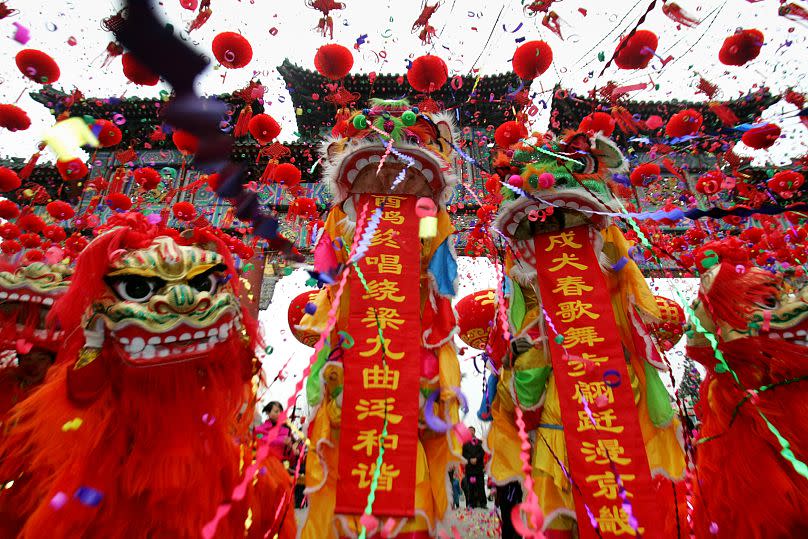 Chinese performers dressed in traditional lion costumes in Beijing