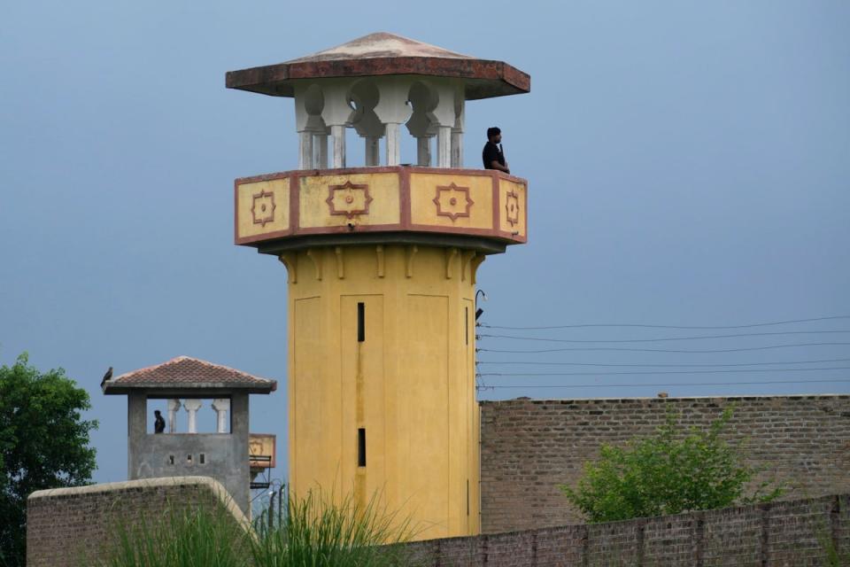 Police officers stand guard on the watchtowers of district prison Attock, where Pakistan’s former prime minister is being held (AP)