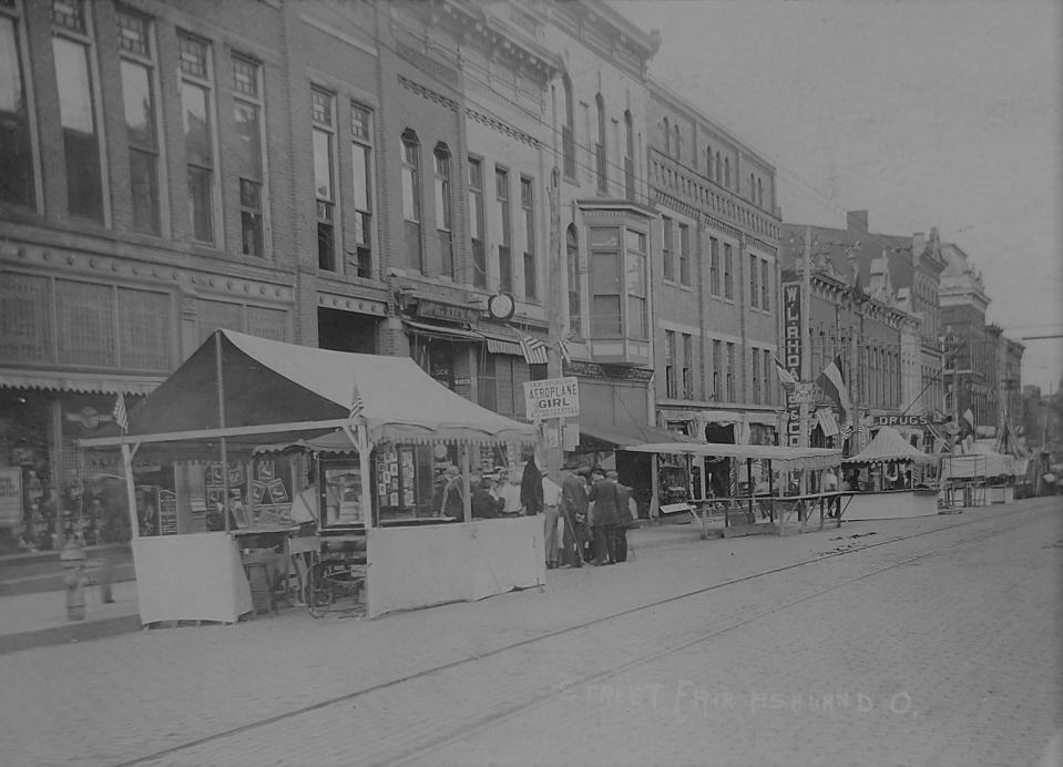 The Miller House can be seen, just to the right of center, to the right of the building with the bow window and to the left of the W.L. Rhoads sign.