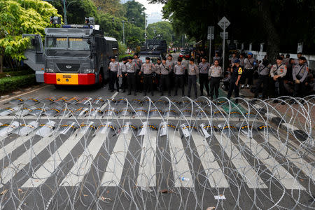 Police officers stand guard outside the General Election Commission (KPU) headquarters following the announcement of the last month's presidential election results in Jakarta, Indonesia, May 21, 2019. REUTERS/Willy Kurniawan