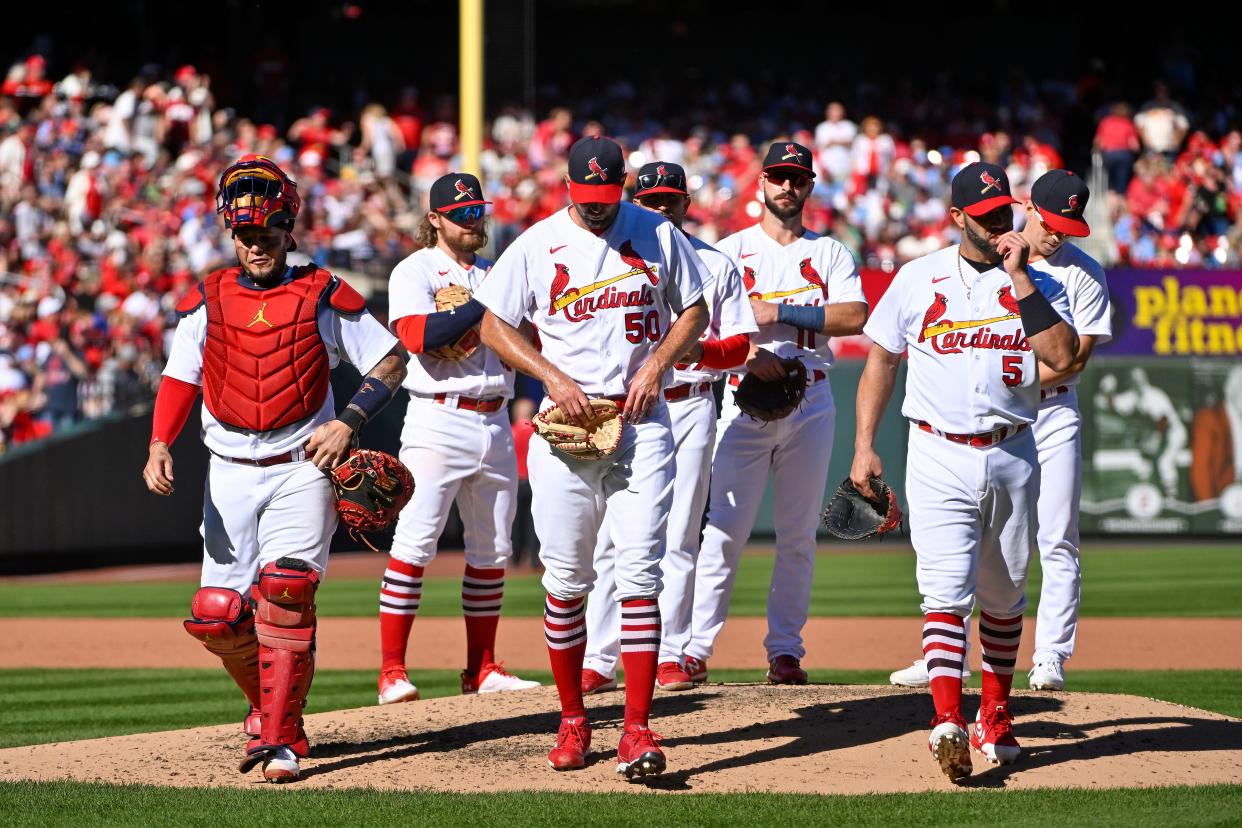 Oct 2, 2022; St. Louis, Missouri, USA;  St. Louis Cardinals catcher Yadier Molina (4) starting pitcher Adam Wainwright (50) and first baseman Albert Pujols (5) walk off the field together after all three were removed from the game during the fifth inning against the Pittsburgh Pirates at Busch Stadium. Mandatory Credit: Jeff Curry-USA TODAY Sports