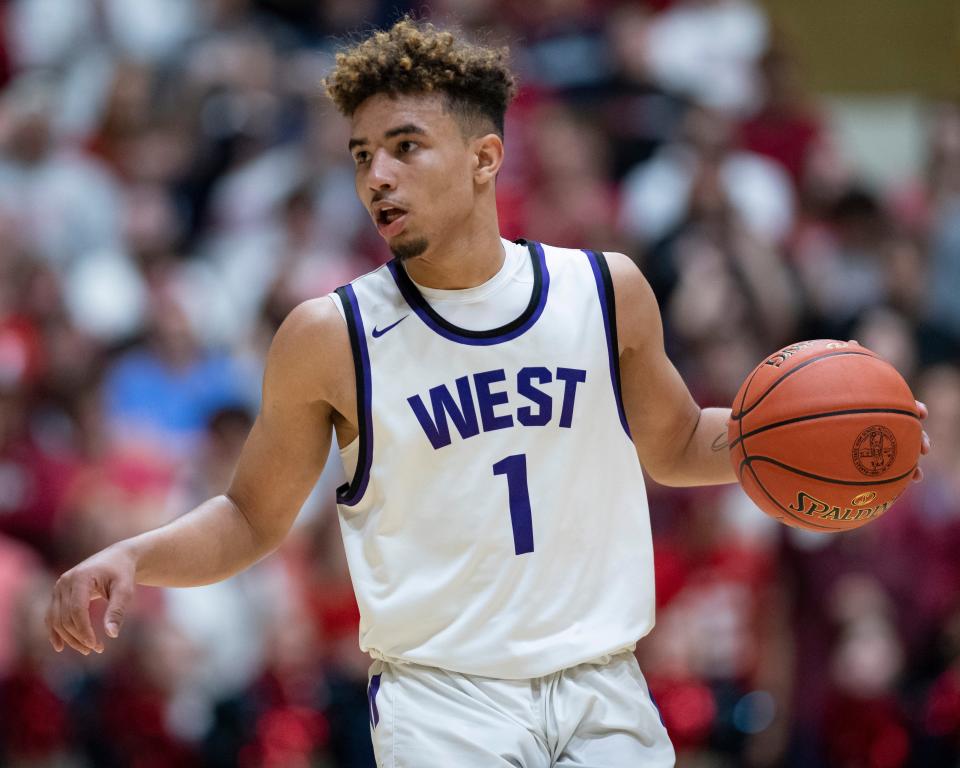 Topeka West's Sincere Austin (1) is dishing out 5.3 assists per game.