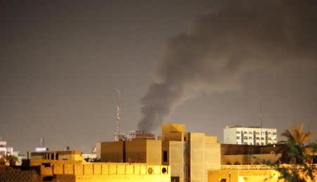 Smoke rises from the site of a car bomb attack in Baghdad October 22, 2014. REUTERS/Thaier Al-Sudani