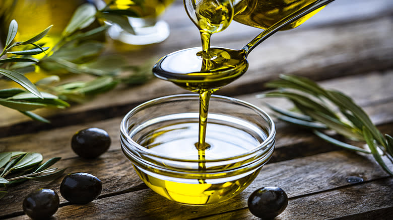 pouring olive oil on spoon