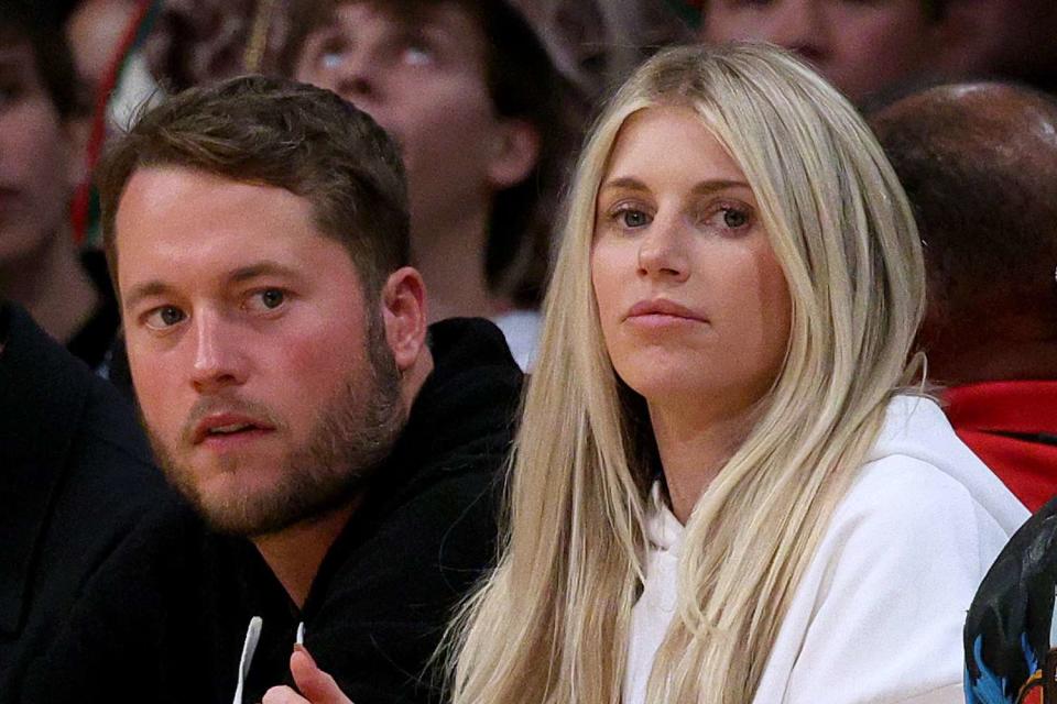 <p> Harry How/Getty</p> Matthew Stafford and wife Kelly Stafford sit courtside