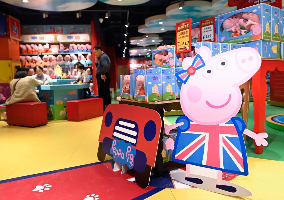 (FILES) In this file photo taken on January 25, 2019, a billboard of Peppa Pig is displayed at a toy store in Beijing. - US toymaker Hasbro announced on August 22, 2019, that it is acquiring studio Entertainment One, which owns popular cartoon series "Peppa Pig" among other children's content, for approximately $4 billion. Under the all-cash transaction, Entertainment One shareholders will receive £5.60 ($6.86) per share, according to a statement from Hasbro. In addition to Peppa Pig, the pink swine with a British accent who loves jumping in muddy puddles, the purchase includes the successful children's cartoon "PJ Masks," about a trio of young friends who become superheroes at night. (Photo by WANG Zhao / AFP)        (Photo credit should read WANG ZHAO/AFP/Getty Images)