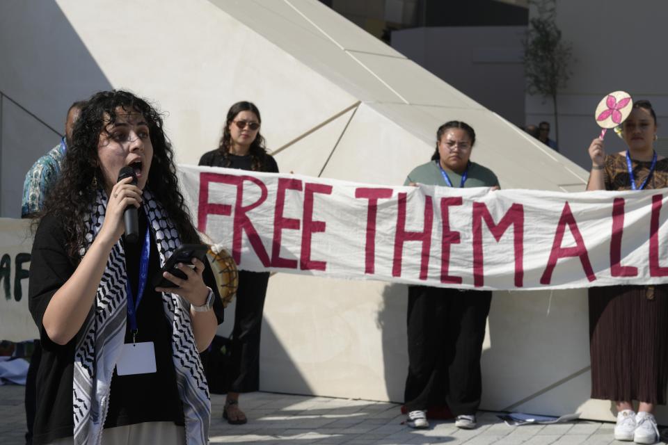 Dalal Shalash speaks during a demonstration calling for a ceasefire in the Israel-Hamas during the COP28 U.N. Climate Summit, Monday, Dec. 11, 2023, in Dubai, United Arab Emirates. (AP Photo/Peter Dejong)