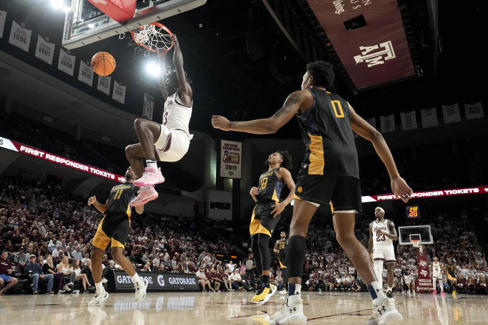 Texas A&M forward Solomon Washington (13) dunks the ball agains Texas A&M Commerce during the first half of an NCAA college basketball game Monday, Nov. 6, 2023, in College Station, Texas. (AP Photo/Sam Craft)
