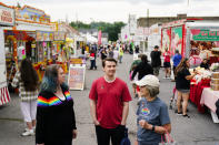 Alisha Hoffman-Mirilovich, left, Mark Shaffer, and Claudia Glennan visit with on another at the Edwardsville Pierogi Festival in Edwardsville, Pa., Friday, June 11, 2021. (AP Photo/Matt Rourke)