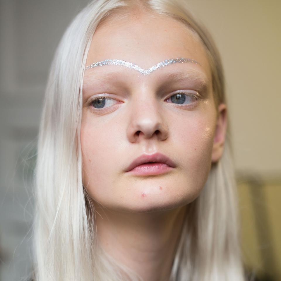 <p>At Giamba, makeup artist Val Garland played with glitter face art in a dazzling shade of iridescent silver.</p>