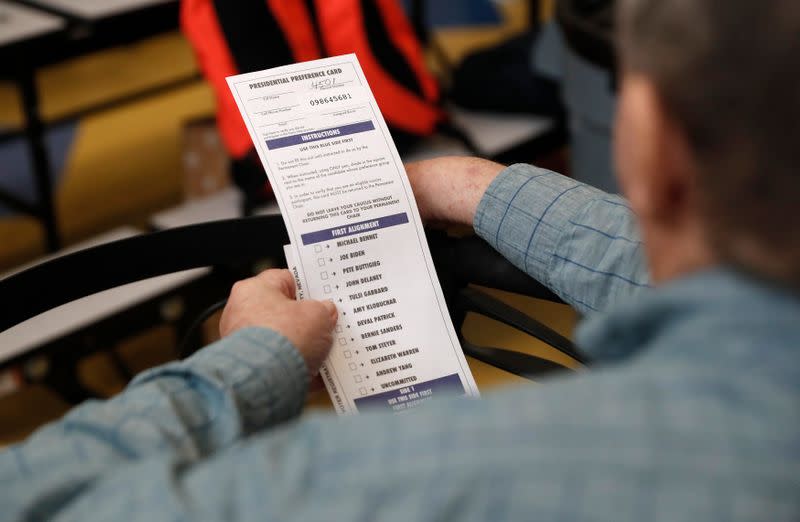 A voter looks at the Presidential Preference sheet used as a ballot in the Nevada Caucus in Henderson