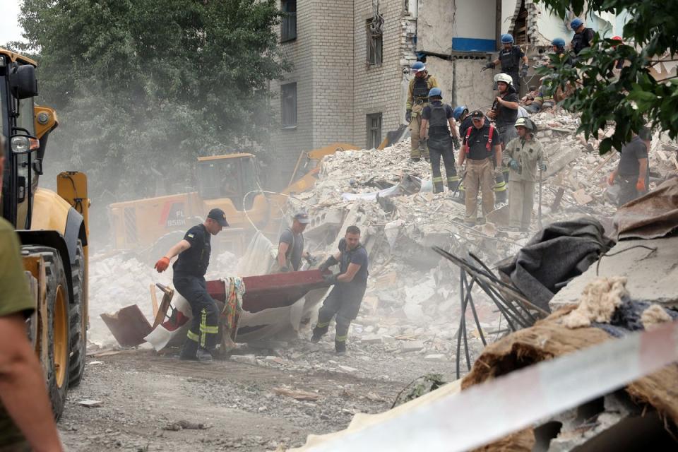 Rescuers clear the scene on Sunday after shelling in the eastern town of Chasiv Yar (AFP/Getty)