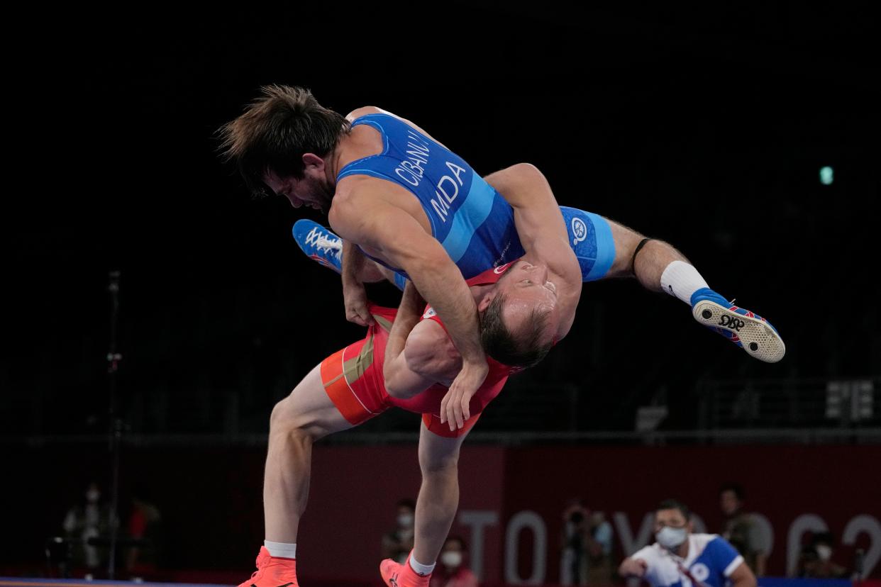 Russian Olympic Committee's Sergey Emelin, bottom, and Moldova's Victor Cionabu compete during the men's 60kg Greco-Roman wrestling bronze medal match at the 2020 Summer Olympics, Monday, Aug. 2, 2021, in Chiba, Japan.