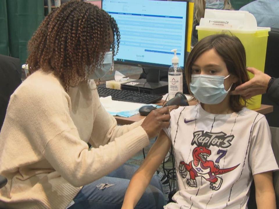 A girl gets her pediatric COVID-19 vaccine at a clinic for children age five to 11 at in Gatineau on Wednesday. Parents and guardians of five- to 11-years old in Yellowknife can start booking appointment for their children Thursday. Appointments begin Friday at the Centre Square Tower vaccine clinic. (Radio-Canada - image credit)