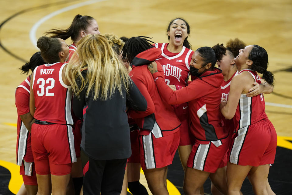 Ohio State players celebrate on the court after their 84-82 overtime victory over Iowa in an NCAA college basketball game, Wednesday, Jan. 13, 2021, in Iowa City, Iowa. (AP Photo/Charlie Neibergall)