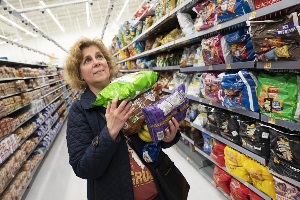 Marcy Seinberg shops at a Walmart Neighborhood Market, Wednesday, April 24, 2019, in Levittown, N.Y. Despite the signs and visible cameras many shoppers, including Seinberg, didn't seem to notice or care. "I am not bothered by it," Seinberg said. "If technology saves me money, I would be interested." (AP Photo/Mark Lennihan)