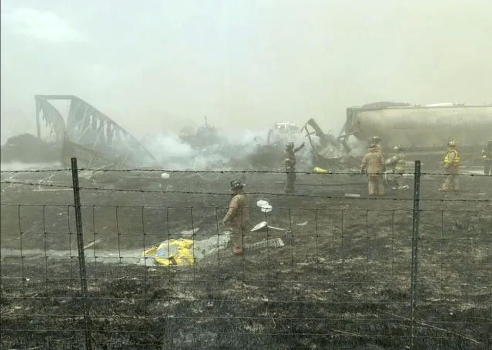 First responders work the scene of a crash involving at least 20 vehicles that shut down a highway in Illinois, Monday, May 1, 2023. Illinois State Police say a windstorm that kicked up clouds of dust in south-central Illinois has led to numerous crashes and multiple fatalities on Interstate 55. (WICS TV via AP)