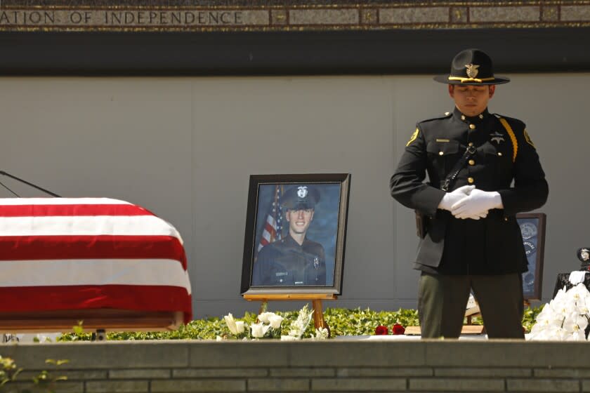 Los Angeles, California-June 22, 2022-A picture of Los Angeles Police Officer Houston R. Tipping is set on the deck where his memorial was held at Forest Lawn Hollywood Hills on June 22, 2022. Family, friends, city officials and fellow officers gather at Forest Lawn Hollywood Hills - Hall of Liberty Mosaic Deck for the funeral of LAPD officer Houston R. Tipping on June 22, 2022. Officer Tipping died after being injured in a training accident recently. (Carolyn Cole / Los Angeles Times)