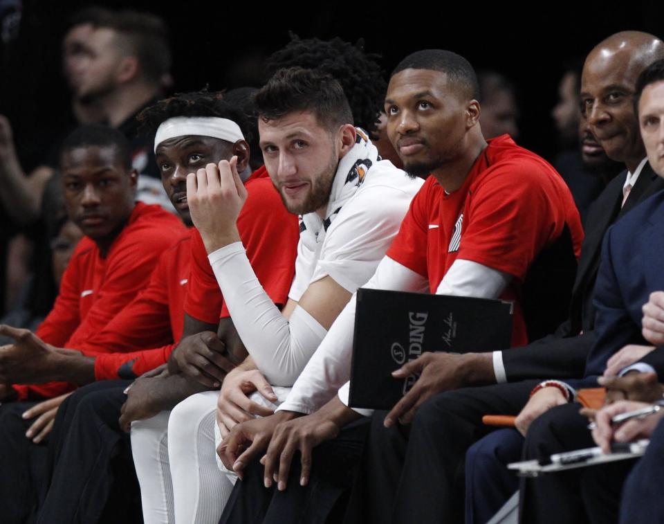 Portland Trail Blazers guard Damian Lillard, right, and center Jusuf Nurkic watch from the bench during the second half of an NBA exhibition basketball game against Maccabi Haifa in Portland, Ore., Friday, Oct. 13, 2017.  (AP Photo/Steve Dipaola)