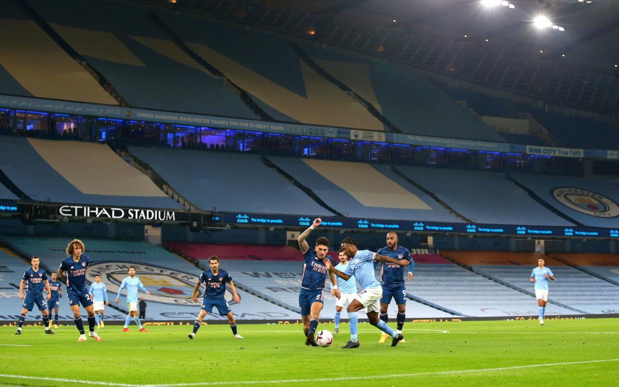 A common, sad sight at the moment as Manchester City host Arsenal in front of empty stands - PA