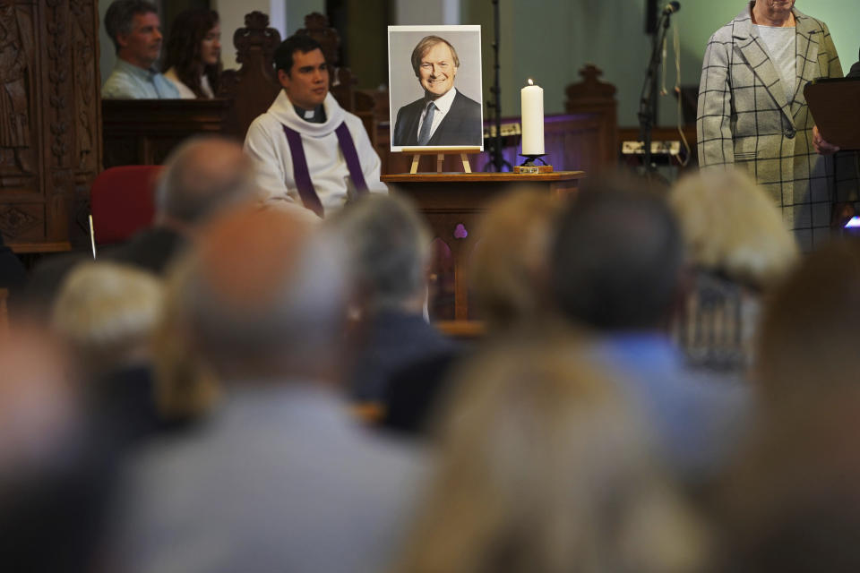 People attend a vigil at St Michael & All Angels church in Leigh-on-Sea in Essex, England, Sunday Oct. 17, 2021 for Conservative MP Sir David Amess who died after he was stabbed several times at a constituency surgery on Friday. (Kirsty O'Connor/PA via AP)