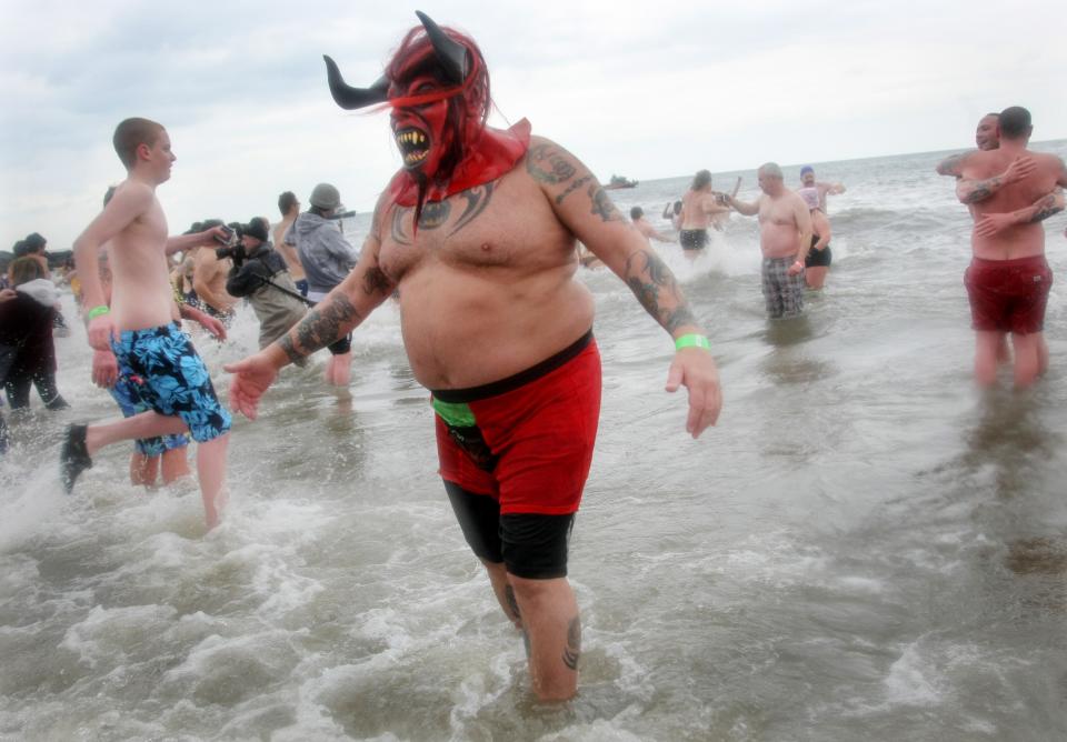 NEW YORK, NY - JANUARY 1: A man wearing a monster mask takes part in the Coney Island Polar Bear Club's New Year's Day swim on January 1, 2013 in the Coney Island neighborhood of the Brooklyn borough of New York City. The annual event attracts hundreds who brave the icy Atlantic waters and temperatures in the upper 30's as a way to celebrate the first day of the new year. (Photo by Monika Graff/Getty Images)