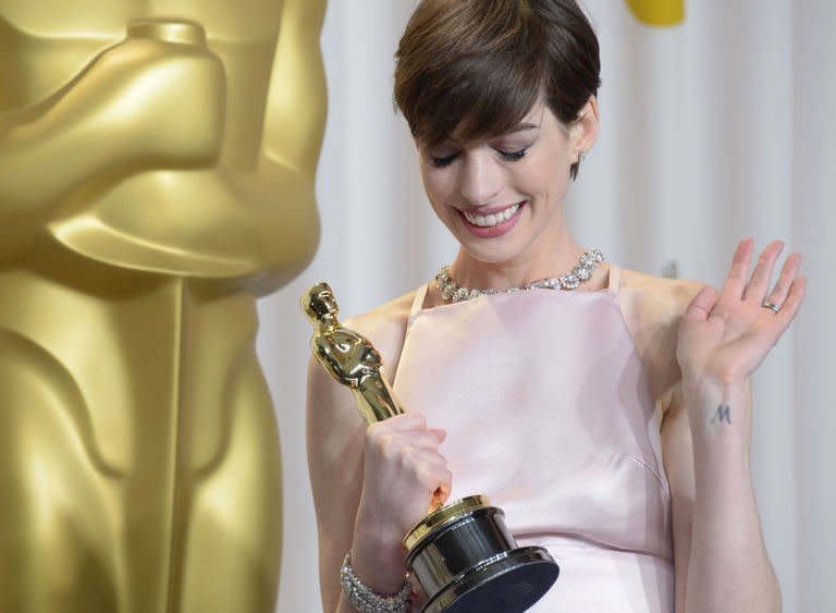 Anne Hathaway celebrates winning the Academy Award for best supporting actress for her role in "Les Miserables" in the press room during the 85th Academy Awards in Hollywood, California on February 24, 2013. Hathaway won an Oscar on her second nomination Sunday, confirming her status as one of Hollywood's brightest acting talents -- and an astonishingly powerful singer who "Dreamed a Dream."