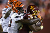 Cincinnati Bengals defensive back Brandon Wilson (40) tackles Washington Football Team running back Jaret Patterson (35) during the first half of a preseason NFL football game Friday, Aug. 20, 2021, in Landover, Md. (AP Photo/Nick Wass)