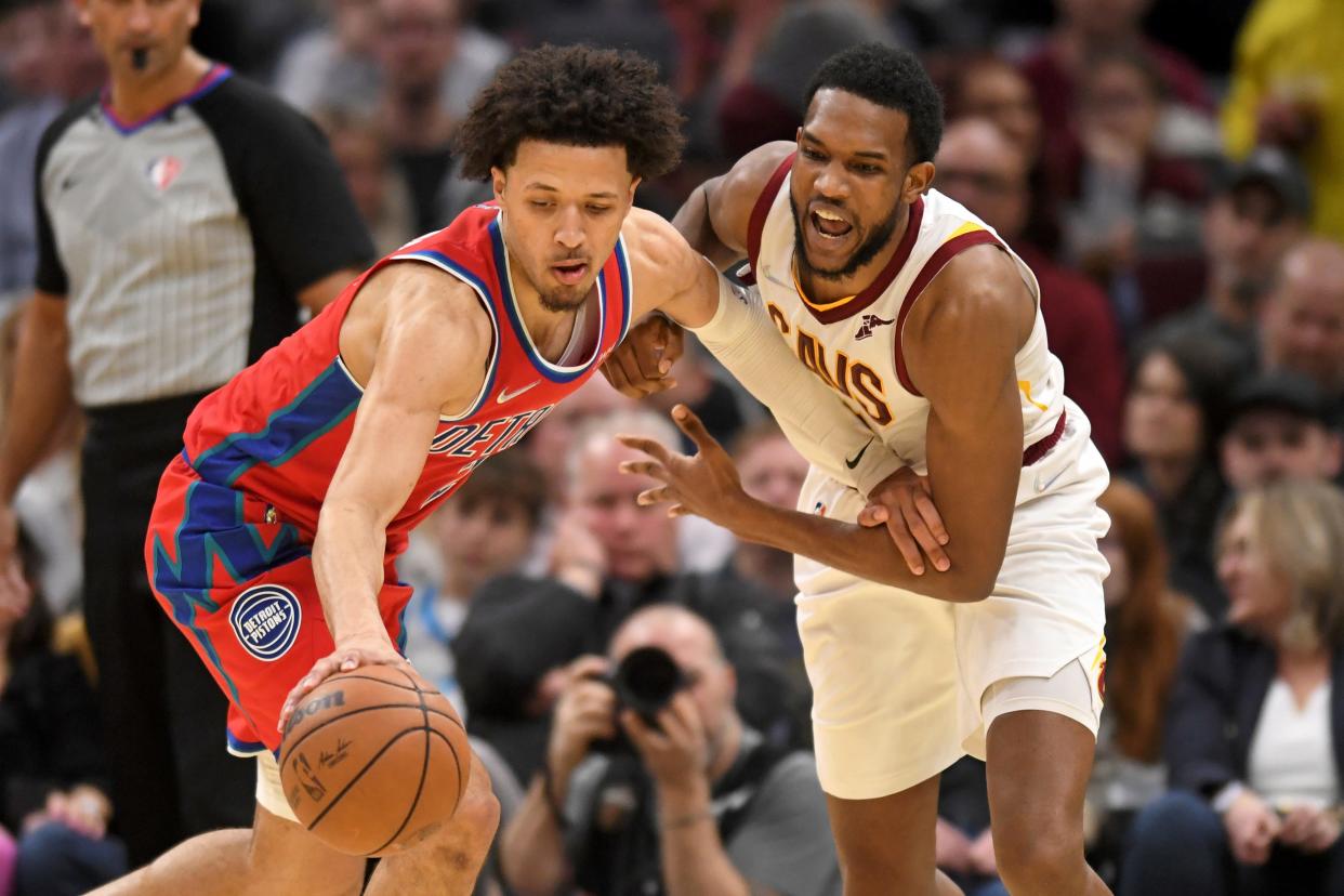 Detroit Pistons' Cade Cunningham (2) steals the ball from Cleveland Cavaliers' Evan Mobley (4) in the second half of an NBA basketball game, Saturday, March 19, 2022, in Cleveland. (AP Photo/Nick Cammett)