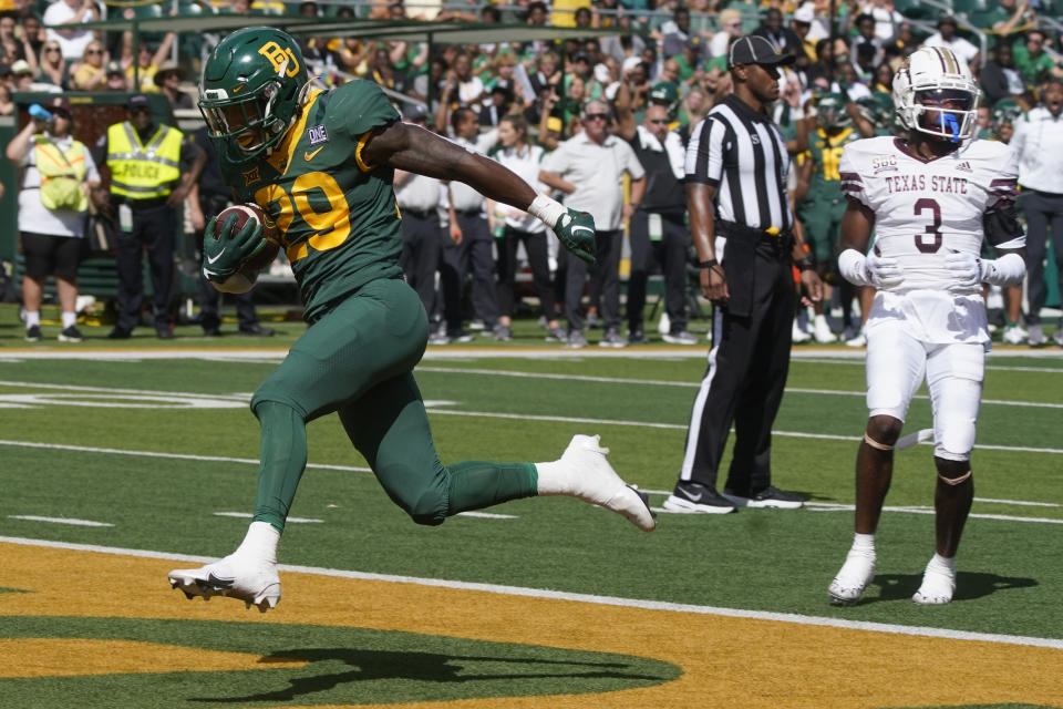 Baylor running back Richard Reese (29 scores a touchdown in front of Texas State cornerback Kordell Rodgers (3) during the first half of an NCAA college football game in Waco, Texas, Saturday, Sept. 17, 2022. (AP Photo/LM Otero)