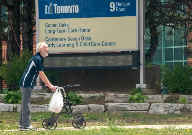 A man takes a walk outside the Seven Oaks Long-Term Care Home in Toronto on Thursday, June 25, 2020. Advocates say as summer temperatures set in, Ontario needs to move as quickly as possible to get air conditioning in all resident rooms in long-term care. (Frank Gunn/The Canadian Press - image credit)
