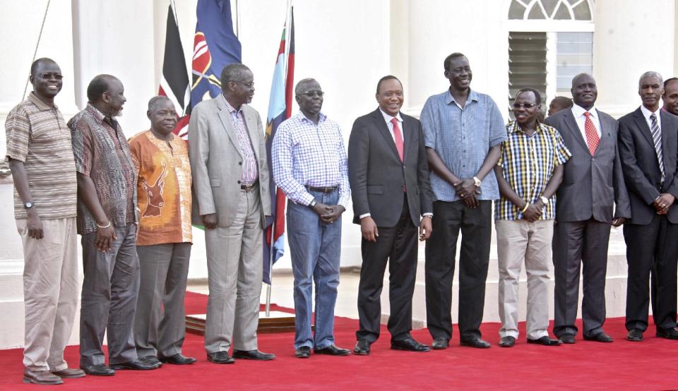 In this photo released by the Kenya Presidency, Kenya's President Uhuru Kenyatta, center, receives seven of the 11 leaders accused of plotting a failed military coup in South Sudan in December, after they were flown to Kenya where they will still be held in custody according to a spokesman for South Sudan's president, in Nairobi, Kenya Wednesday, Jan. 29, 2014. South Sudan's Justice Minister Paulino Wanawilla Unago said the detainees will be in Kenya for the duration of the investigation "for their own safety" but will return to face trial. At 2nd right is retired Kenyan General Lazaro Sumbeiywo and Director-General of Kenya's National Security Intelligence Service (NSIS) Michael Gichangi, is at far right. (AP Photo/Kenya Presidency)