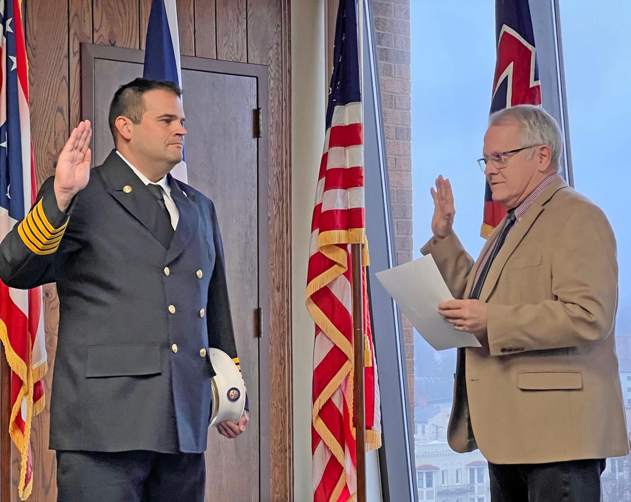 Mansfield Mayor Tim Theaker swears in the new Mansfield Fire Department Chief Dan Crow on Friday afternoon.
