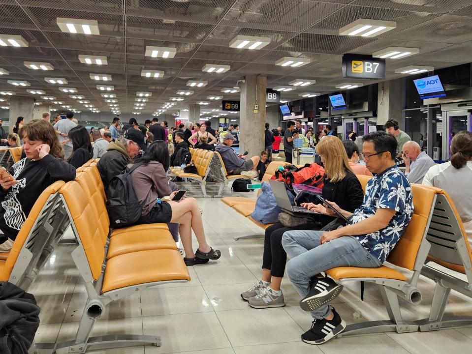 Stranded passengers from Singapore Airlines flight SQ321 wait for a relief flight after an emergency landing at Bangkok’s Suvarnabhumi International Airport, in Bangkok, Thailand 21 May 2024 (Reuters)