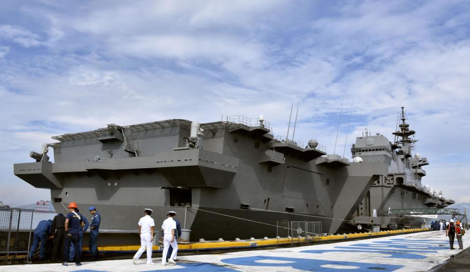 In the Sept. 1, 2018 photo, Japan's helicopter carrier J JS Kaga stops at Subic port in Zambales province, the Philippines. The Japanese navy’s largest ship has joined up with the USS Ronald Regan aircraft carrier strike group for joint exercises in the South China Sea, the latest sign of Japan’s increased presence in the region on which it depends for much of its foreign trade. Joined by two guided missile destroyers, JS Kaga is on a southern cruise that includes port calls in India, Sri Lanka, Singapore, Indonesia and the Philippines. (Kyodo News via AP)