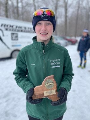 Cora Hinsdill with her state title trophy on Tuesday, February 28, 2023, at Bristol Mountain.