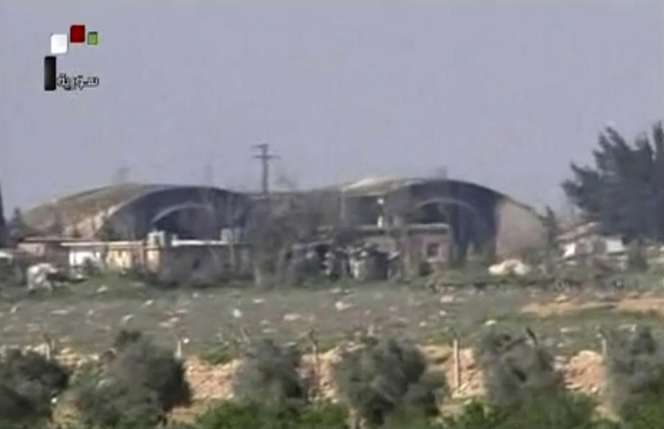 FILE - In this Friday April, 7, 2017 file frame grab from video provided by the Syrian official TV, a Syrian government channel that is consistent with independent AP reporting, shows the burned and damaged hangar warplanes which attacked by U.S. Tomahawk missiles, at the Shayrat Syrian government forces airbase, southeast of Homs, Syria. A spokesman for the U.S.-led coalition said Friday, Jan. 11, 2019 that the process of withdrawal in Syria has begun, declining to comment on specific timetables or movements. (Syrian government TV, via AP, File)