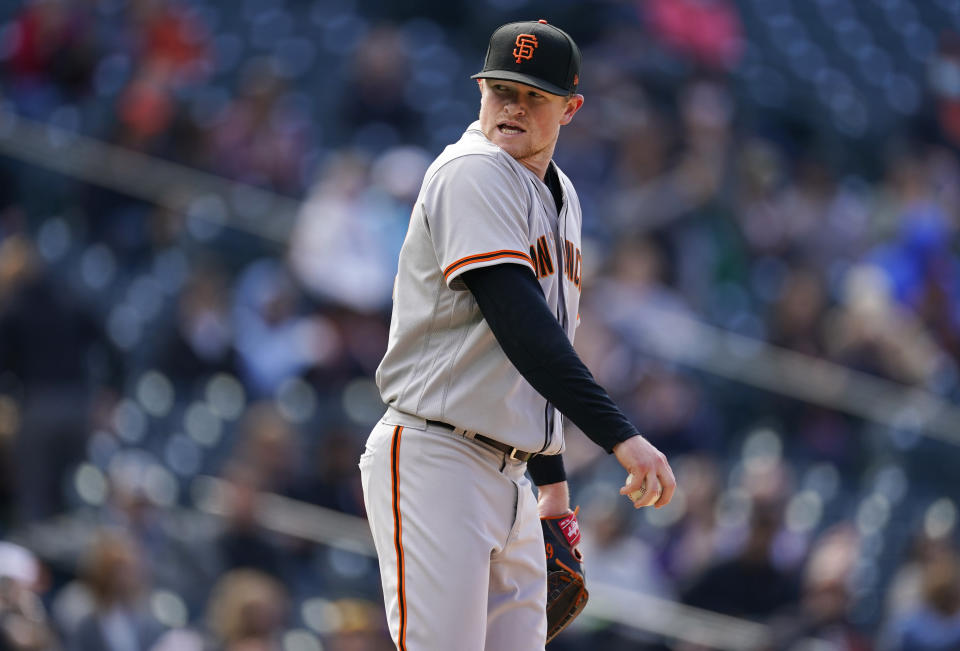 San Francisco Giants starting pitcher Logan Webb reacts after walking Colorado Rockies 'Alan Trejo with the bases loaded during the fourth inning of a baseball game Wednesday, May 5, 2021, in Denver. (AP Photo/David Zalubowski)