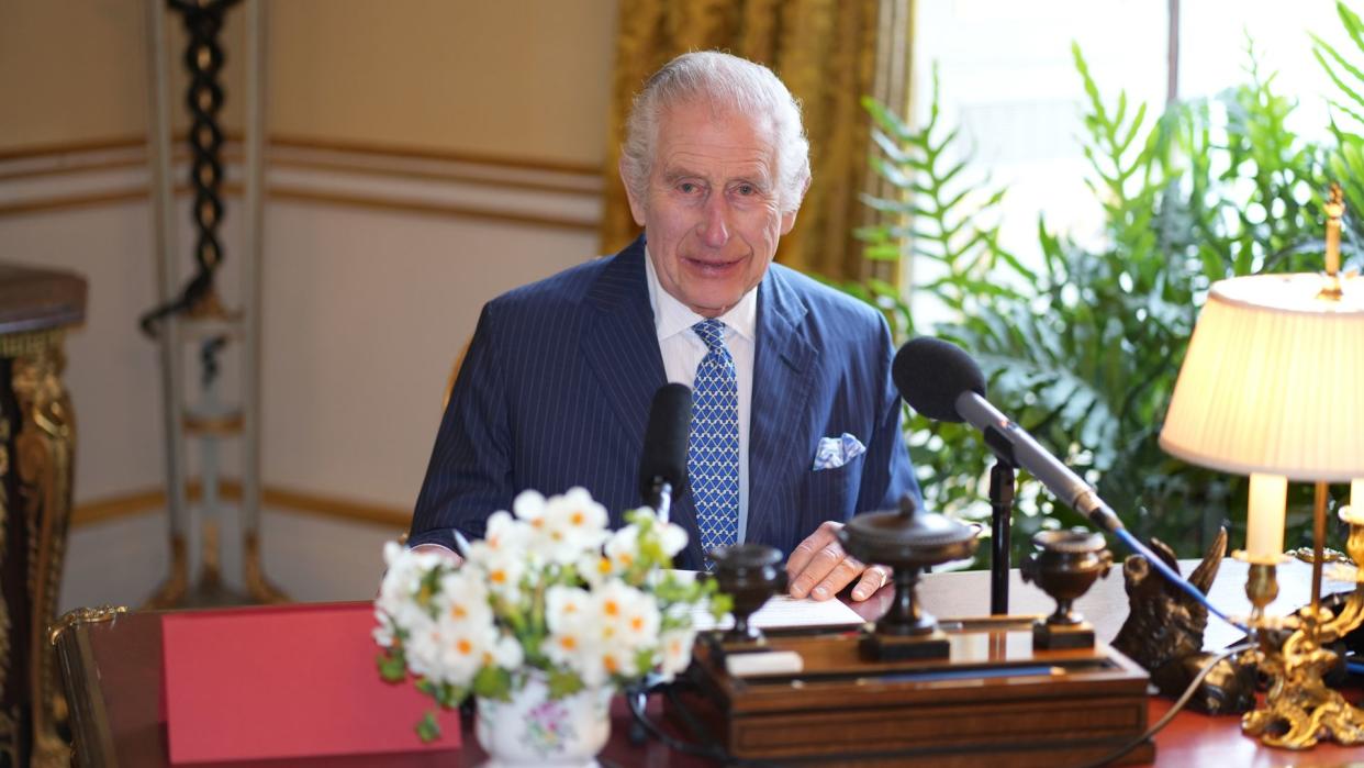 King Charles behind his desk at Buckingham Palace