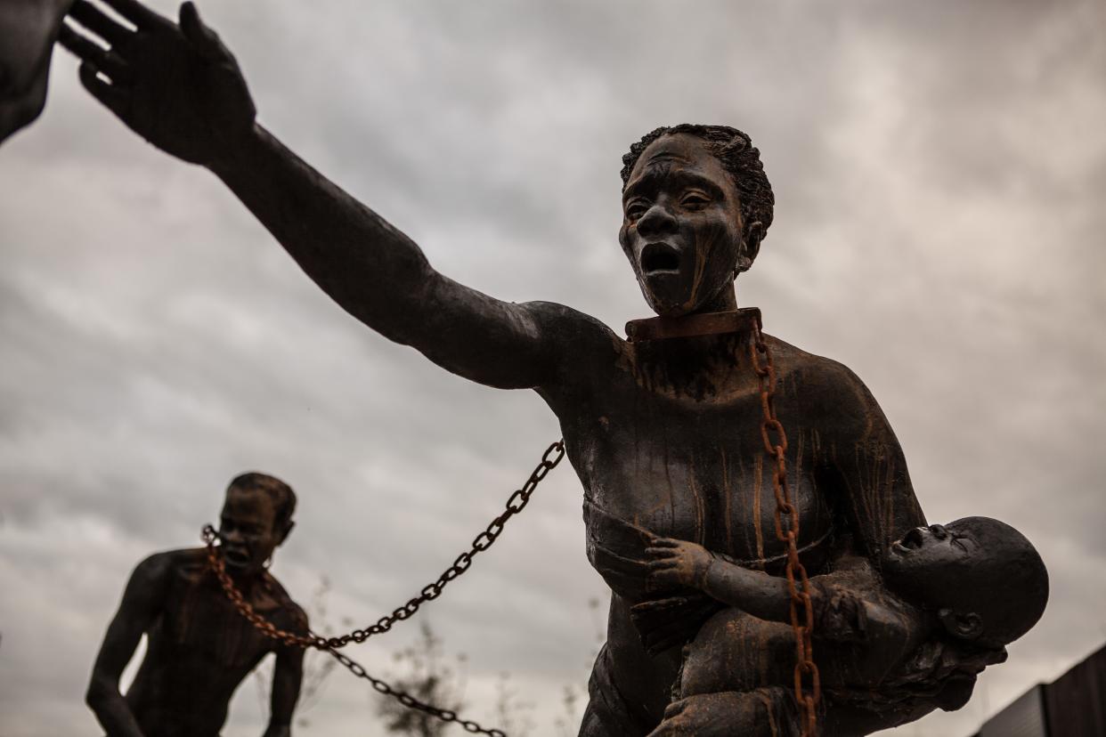 Nkyinkim sculpture installation of enslaved people by Ghanian sculptor Kwame Akoto Bamfo stands at the entrance of the National Museum for Peace and Justice.