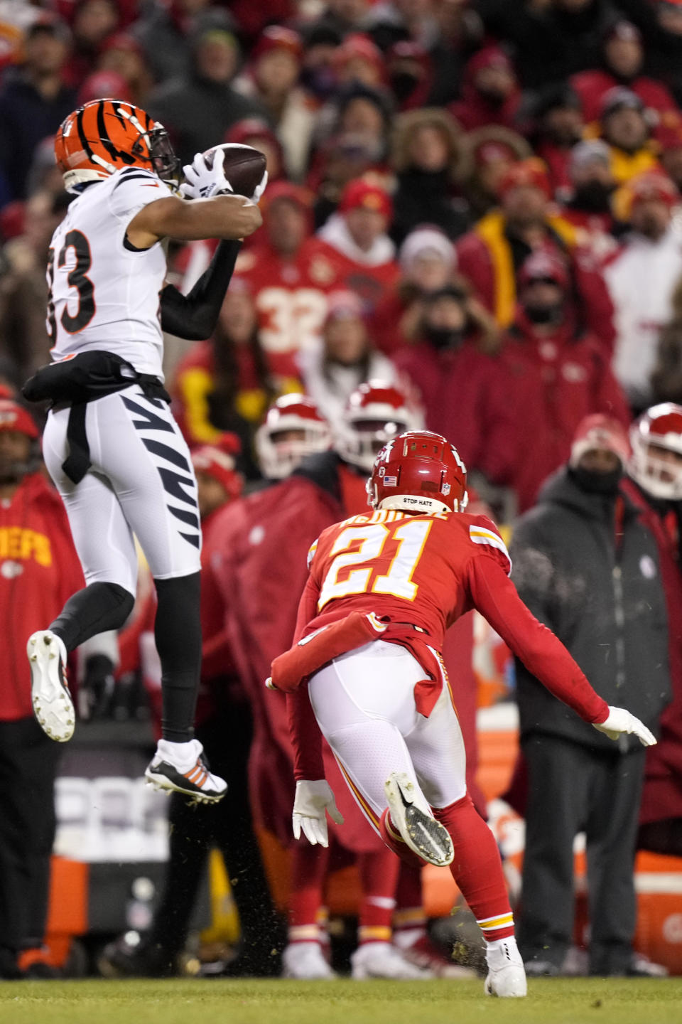 Cincinnati Bengals wide receiver Tyler Boyd (83) makes the catch ahead of Kansas City Chiefs cornerback Trent McDuffie (21) during the first half of the NFL AFC Championship playoff football game, Sunday, Jan. 29, 2023, in Kansas City, Mo. (AP Photo/Charlie Riedel)