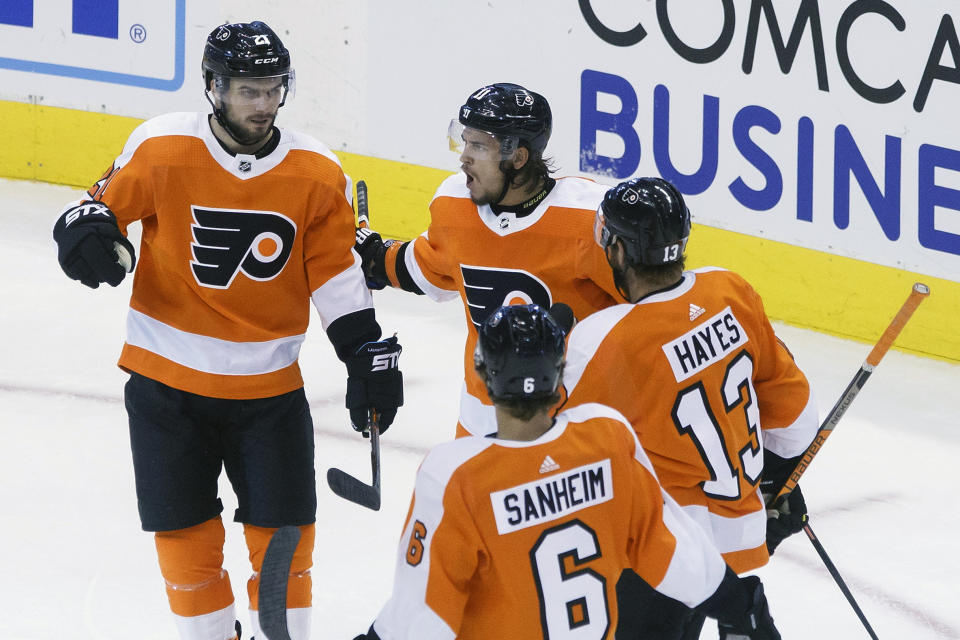 Philadelphia Flyers center Scott Laughton (21) celebrates his goal alongside teammates Travis Konecny (11), Kevin Hayes (13) and Travis Sanheim (6) during the third period of an NHL hockey playoff game Thursday, Aug. 6, 2020, in Toronto. (Cole Burston/The Canadian Press via AP)