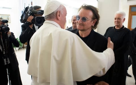 Pope Francis welcoming Irish band U2 Paul David Hewson, known by his stage name Bono (R), prior their meeting at the Vatican - Credit: AFP