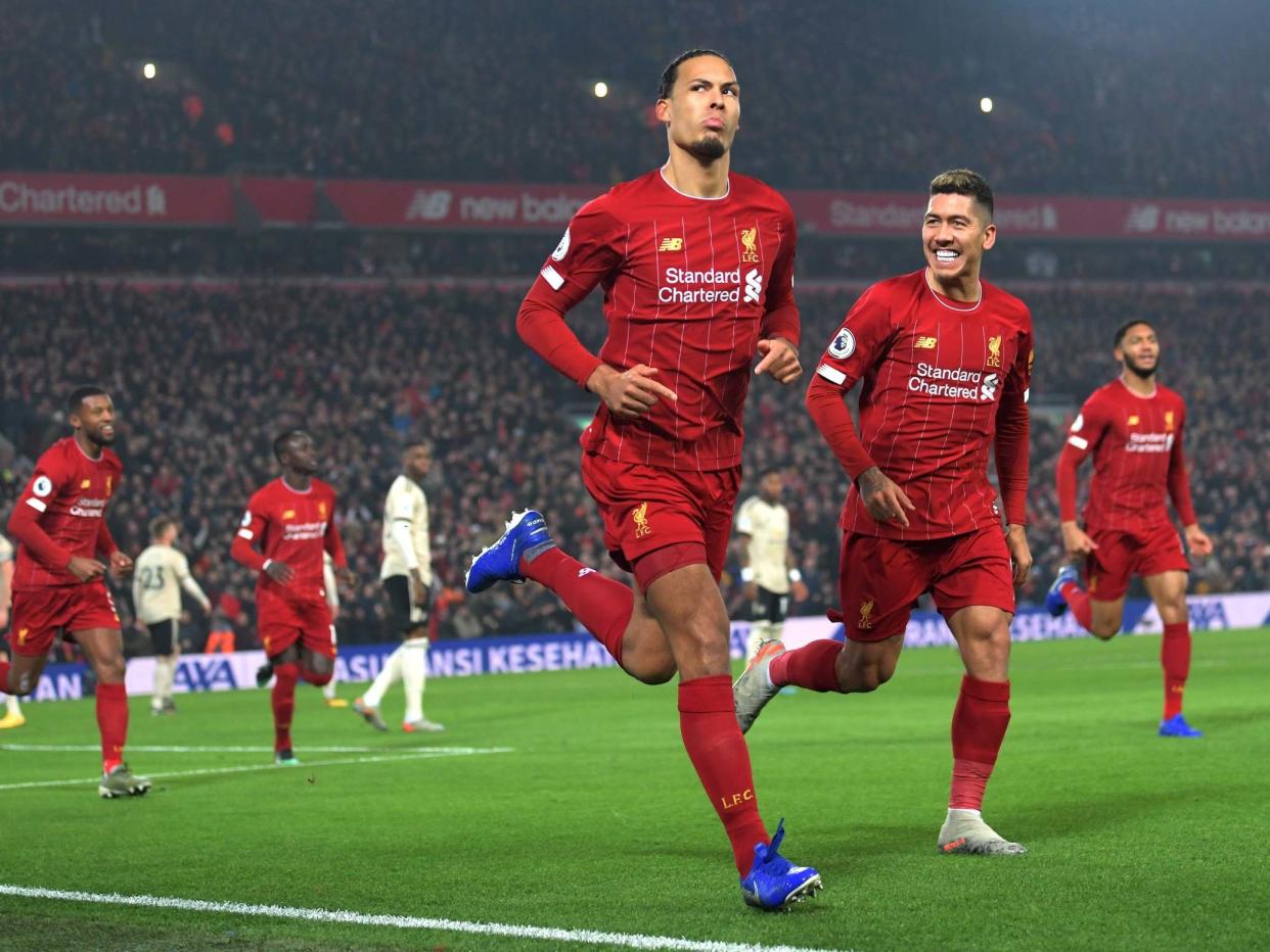 Virgil van Dijk of Liverpool celebrates with Roberto Firmino: Getty Images