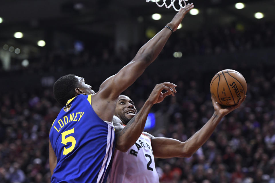 Toronto Raptors forward Kawhi Leonard (2) shoots as Golden State Warriors center Kevon Looney (5) defends during the second half of Game 1 of basketball’s NBA Finals, Thursday, May 30, 2019, in Toronto. (Frank Gunn/The Canadian Press via AP)