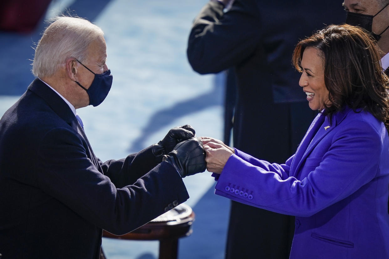 WASHINGTON, DC - JANUARY 20:  U.S. President-elect Joe Biden fist bumps newly sworn-in Vice President Kamala Harris after she took the oath of office on the West Front of the U.S. Capitol on January 20, 2021 in Washington, DC. Biden was sworn in today as the 46th president of the United States. (Photo by Drew Angerer/Getty Images)