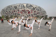 Chinese young athletes practice Taekwondo techniques before the rehearsal of ceremony to mark 100-day countdown to London 2012 Olympic Games outside the Bird's Nest on April 17, 2012 in Beijing, China. The 100-day countdown to London 2012 Olympic Games falls on April 18, 2012. (Photo by Feng Li/Getty Images)