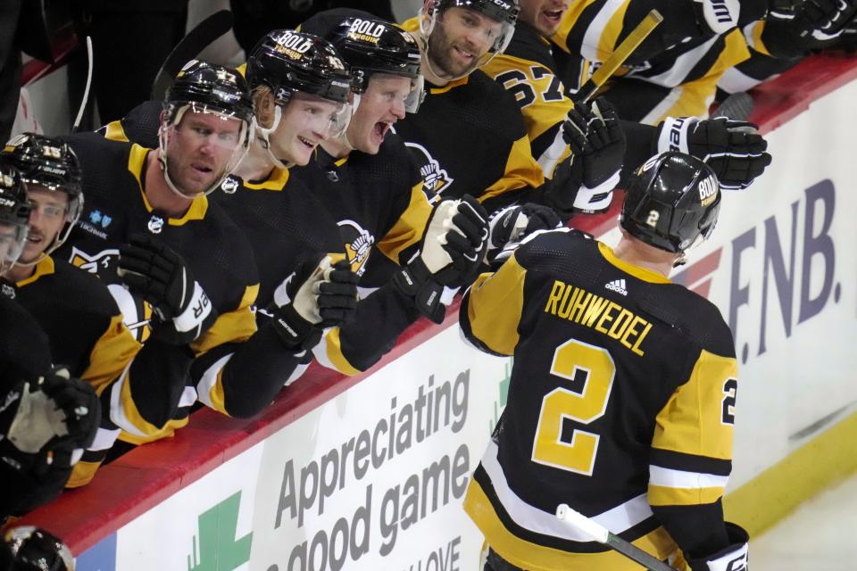 Pittsburgh Penguins' Chad Ruhwedel (2) returns to the bench after scoring during the first period of an NHL hockey game against the Washington Capitals in Pittsburgh, Saturday, March 25, 2023. (AP Photo/Gene J. Puskar)